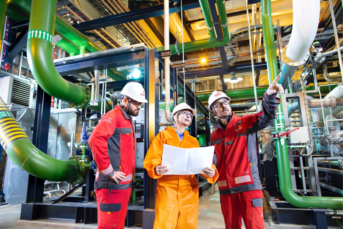 Workers in a production facility, wearing protective suits