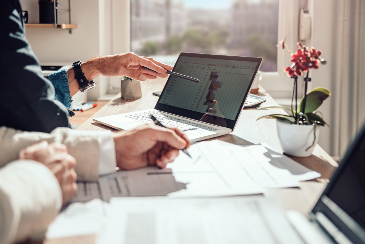 Businessman sitting by the desk and analyzing project timeline