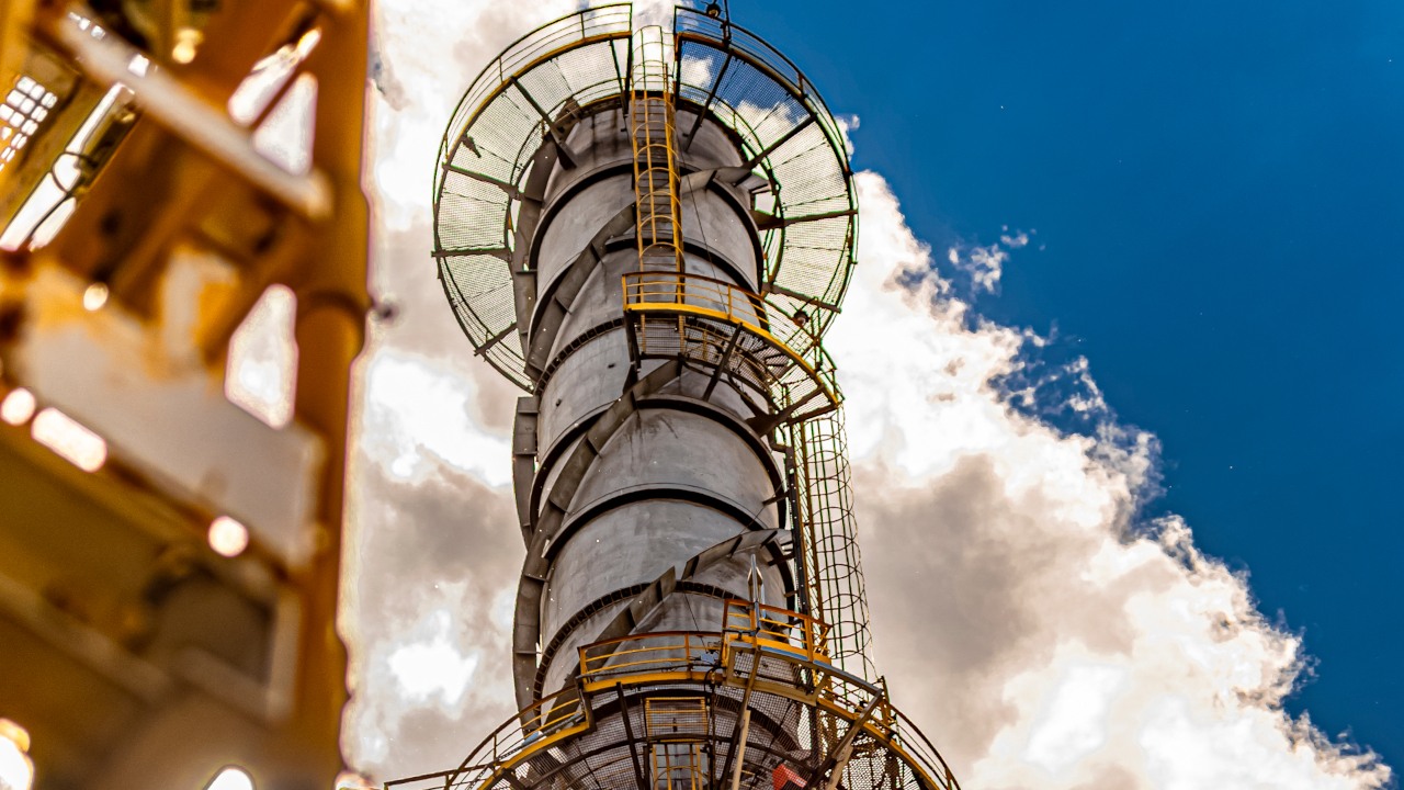 The chimney at the ORLEN production facility against the sky