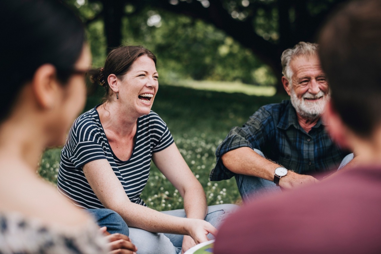 Cheerful woman in the park with her friends