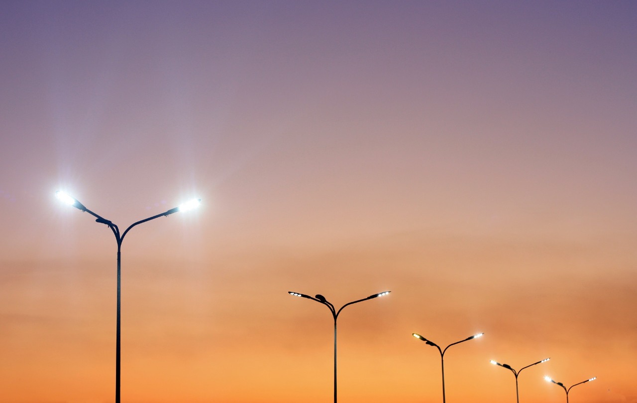 Urban landscape with modern minimal street lights and vibrant sky. Vivid city background.