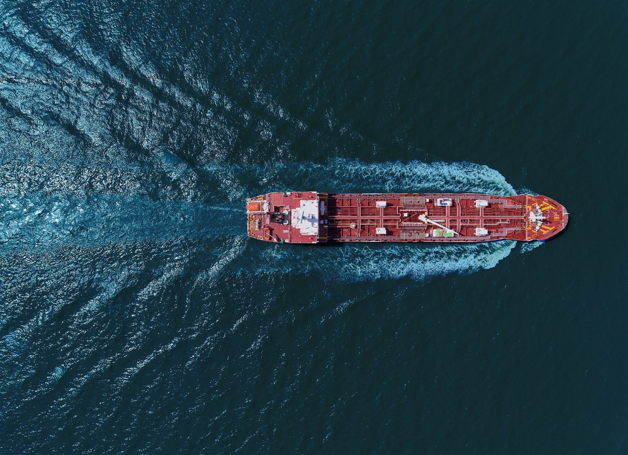 Aerial top view Oil tanker ship transportation oil from refinery with beautiful wave on the sea.