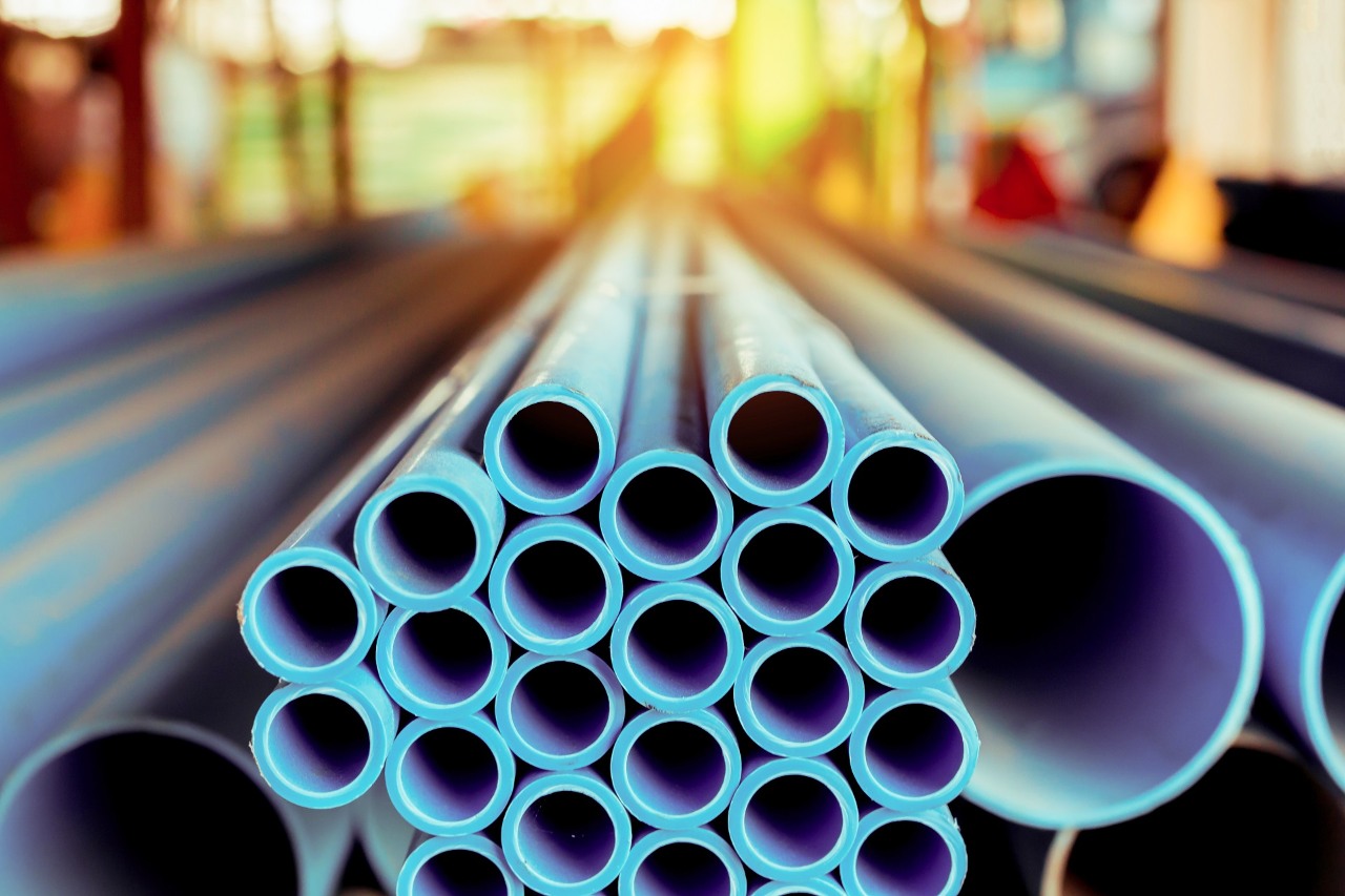 Close up to blue plastic pipe background, PVC pipes stacked in warehouse,  PVC water pipes used for construction