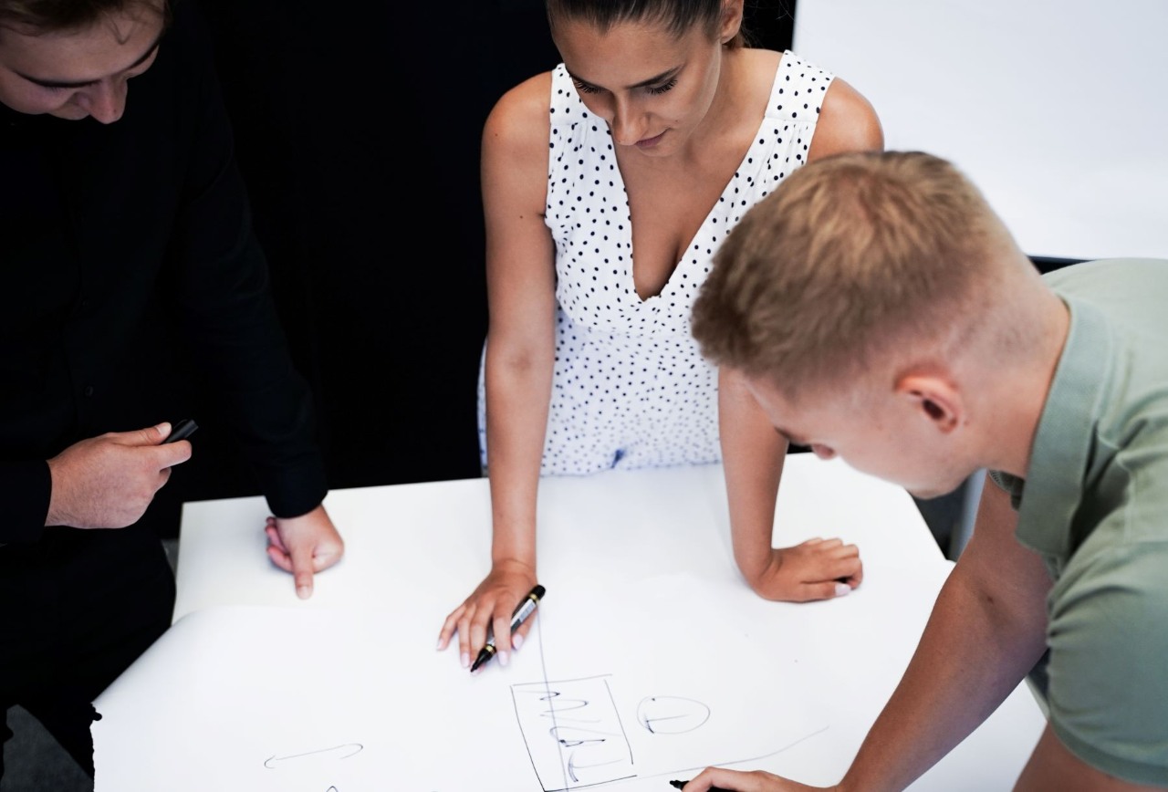 Grupa uśmiechniętych osób prezentuje statuetkę TOP Employer