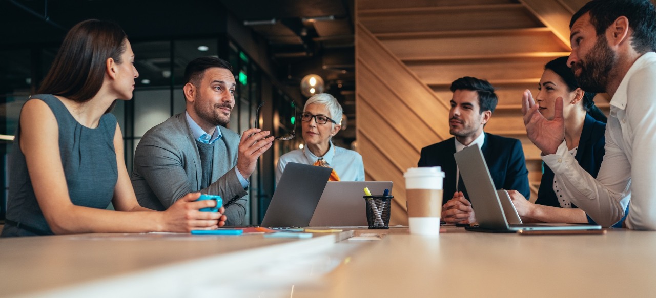 Modern business people discussing new business ideas during meeting in the office